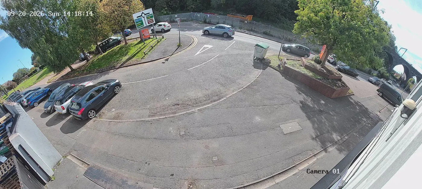 Live CCTV frame from a wide-angle camera over a car park and roundabout at Chapel Ash, Wolverhampton, with the A449 Stafford Road sign visible